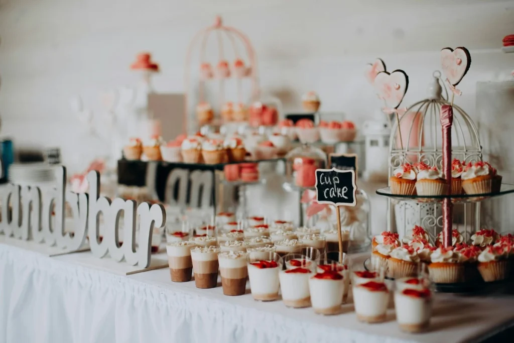 Dessert table setup with cupcakes and sweet treats for elegant event decoration.